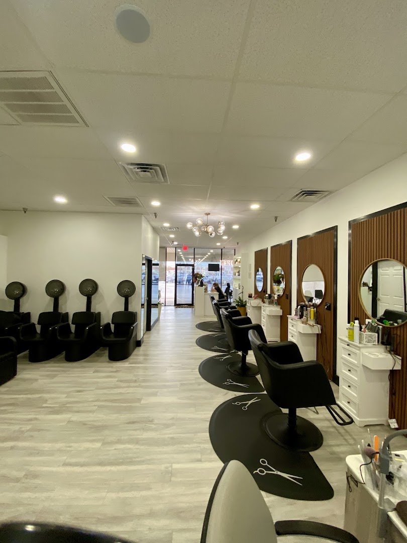Hair styling station with salon chairs and mirrors.
